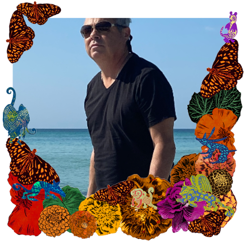 Photo of Joe Tullos in a frame with marigolds, flowers, alebrijes and monarch butterflies.