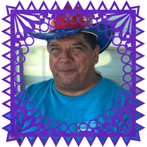 Photo of John Edward Mejia in a frame with papel picado.