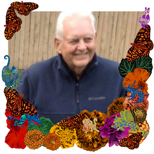 Photo of John Pruess in a frame with marigolds, flowers, alebrijes and monarch butterflies.