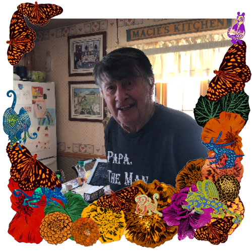 Photo of Joseph Rampolla in a frame with marigolds, flowers, alebrijes and monarch butterflies.