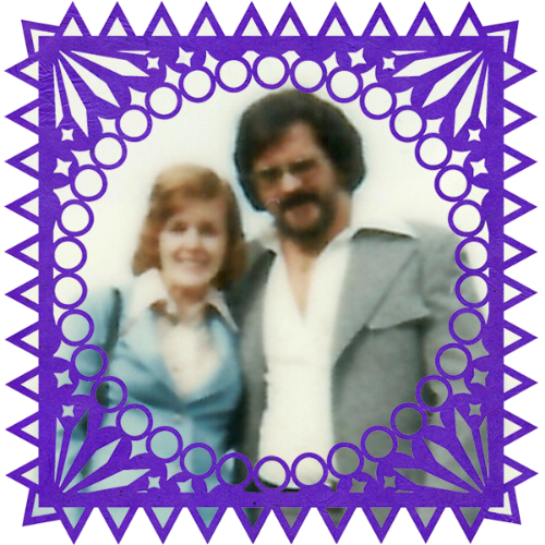 Photo of Joyce & Gib Clark in a frame with papel picado.
