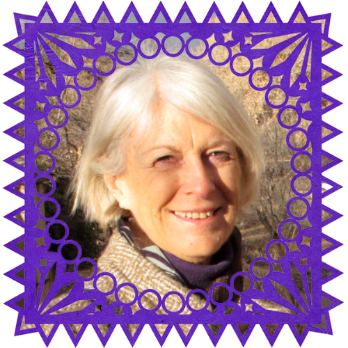 Photo of Judy in a frame with papel picado.