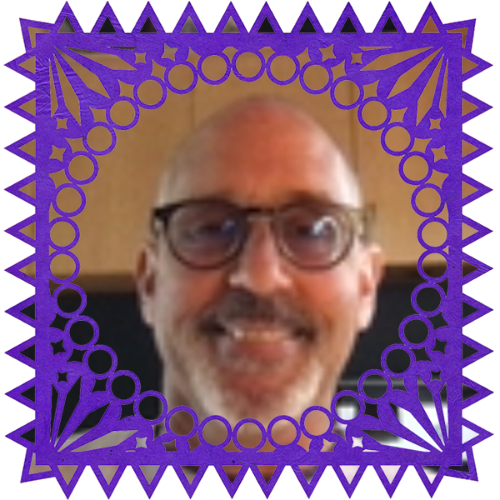 Photo of Lance Wylie in a frame with papel picado.