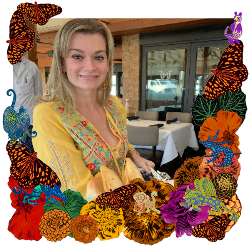Photo of Lauren Mendelson in a frame with marigolds, flowers, alebrijes and monarch butterflies.