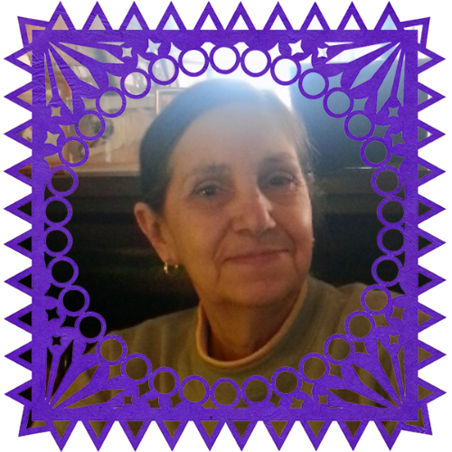 Photo of Linda in a frame with papel picado.