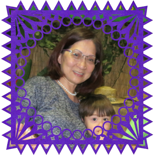 Photo of Linda Hsu in a frame with papel picado.