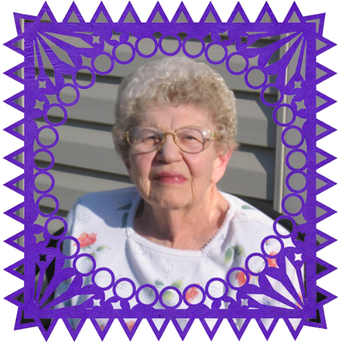 Photo of Lois Jane Swindler in a frame with papel picado.