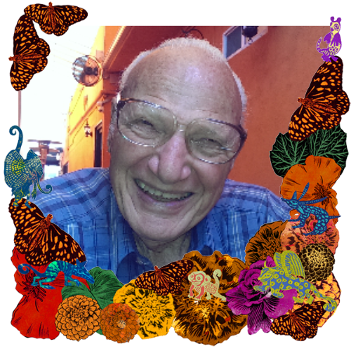 Photo of Loran Markson in a frame with marigolds, flowers, alebrijes and monarch butterflies.