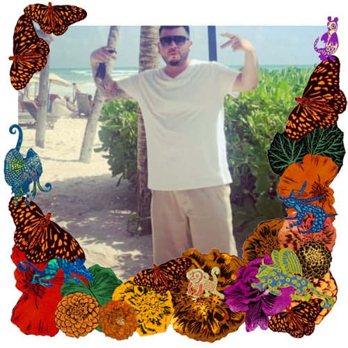 Photo of Marco A. Landey in a frame with marigolds, flowers, alebrijes and monarch butterflies.