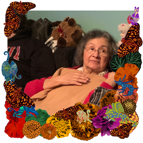Photo of Margaret Rodriguez in a frame with marigolds, flowers, alebrijes and monarch butterflies.