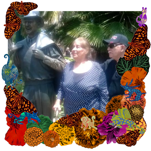 Photo of Maria Barrios in a frame with marigolds, flowers, alebrijes and monarch butterflies.