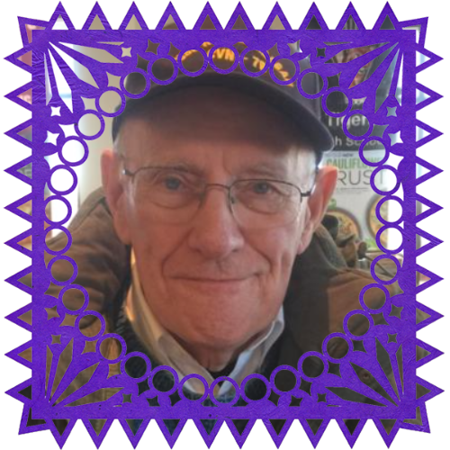 Photo of Mi padre in a frame with papel picado.