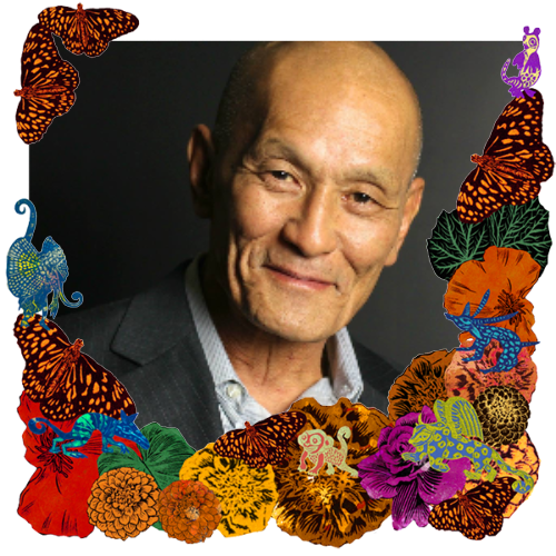 Photo of Mike Fukuyama in a frame with marigolds, flowers, alebrijes and monarch butterflies.
