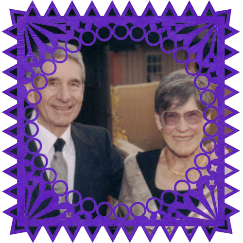 Photo of Mike & Judy Johnson in a frame with papel picado.