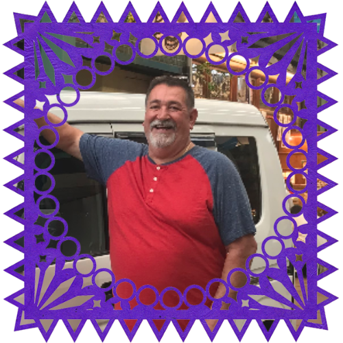 Photo of My Dad in a frame with papel picado.