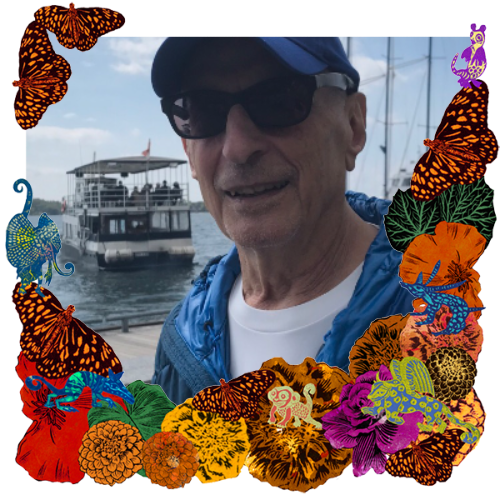 Photo of My dad in a frame with marigolds, flowers, alebrijes and monarch butterflies.
