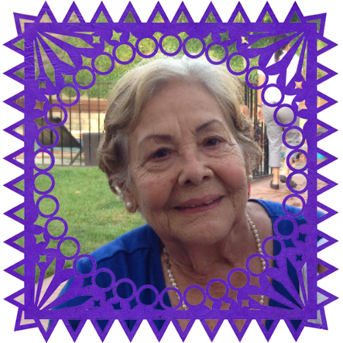 Photo of My grandmother in a frame with papel picado.