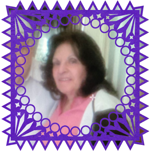 Photo of My grandmother in a frame with papel picado.