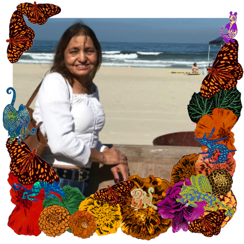 Photo of My mother in a frame with marigolds, flowers, alebrijes and monarch butterflies.