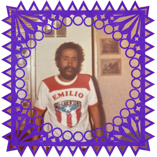 Photo of My brother in a frame with papel picado.