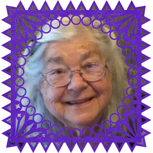 Photo of Nana in a frame with papel picado.