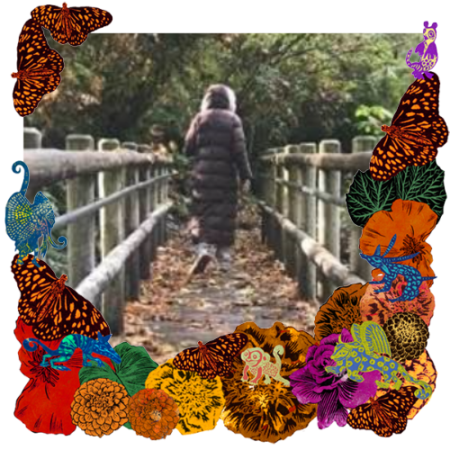 Photo of Nancy Elizabeth in a frame with marigolds, flowers, alebrijes and monarch butterflies.