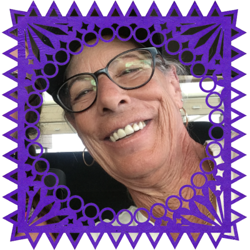 Photo of Nancy Mertzweiller in a frame with papel picado.