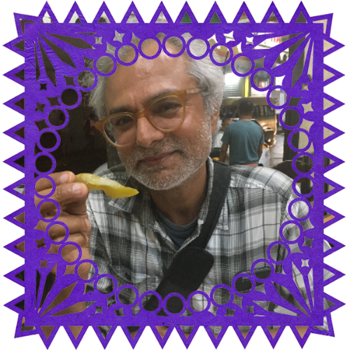 Photo of Nick Oza in a frame with papel picado.