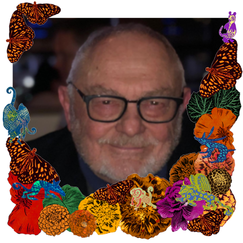 Photo of Paul Kellogg in a frame with marigolds, flowers, alebrijes and monarch butterflies.