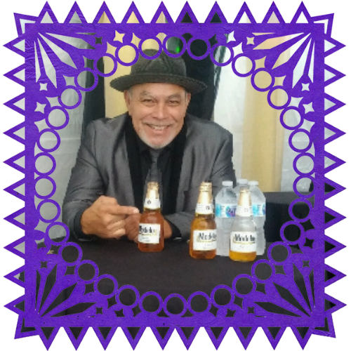 Photo of Rafael Muñoz in a frame with papel picado.