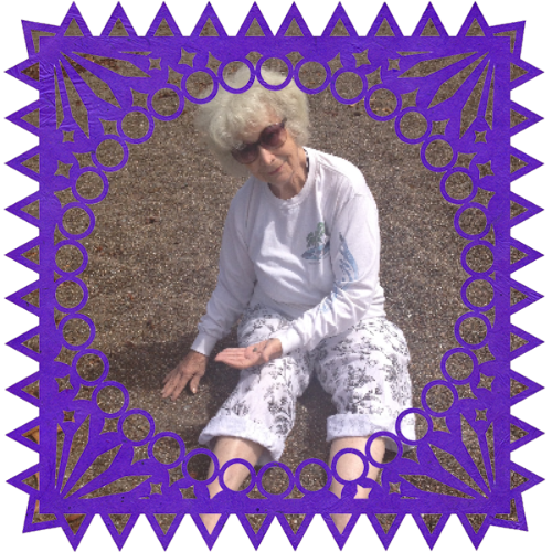 Photo of Regina Rocha in a frame with papel picado.
