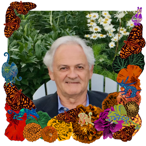 Photo of Robert Corless in a frame with marigolds, flowers, alebrijes and monarch butterflies.