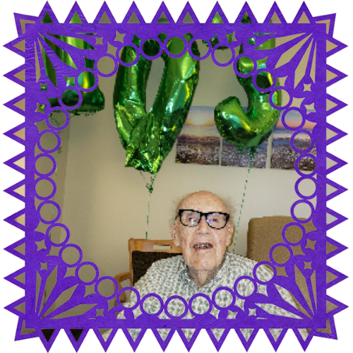 Photo of Robert Stuart Williamson in a frame with papel picado.
