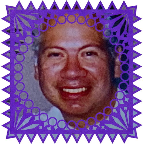Photo of Ruben Ybarra in a frame with papel picado.
