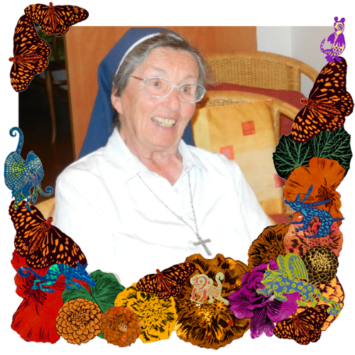 Photo of Sister Vera Marie in a frame with marigolds, flowers, alebrijes and monarch butterflies.