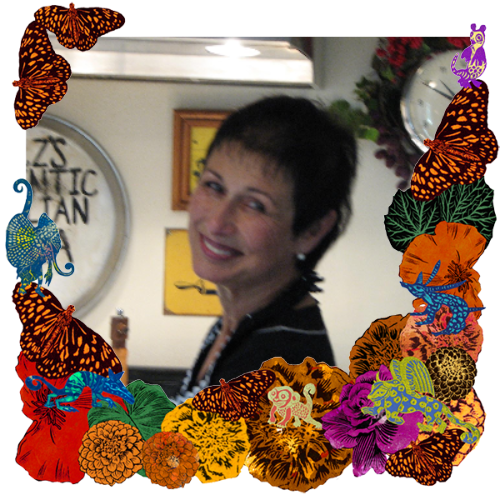 Photo of Suz Montgomery in a frame with marigolds, flowers, alebrijes and monarch butterflies.