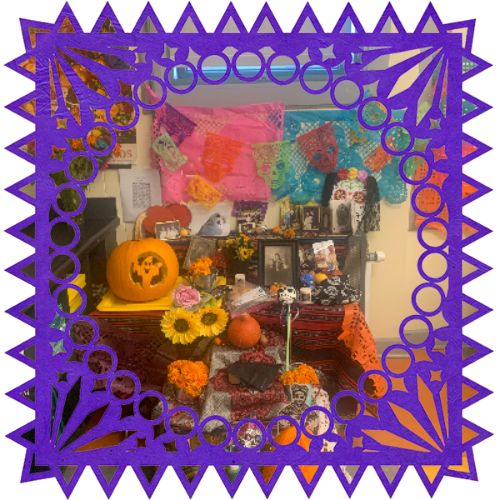 Photo of Third grade class' loved ones in a frame with papel picado.