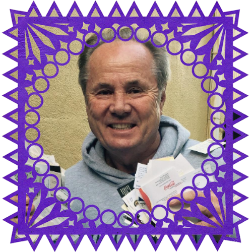 Photo of Tom LaBonge in a frame with papel picado.