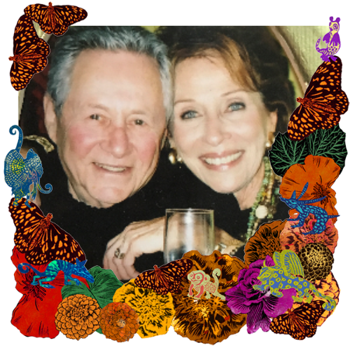 Photo of Warren & Roz Steinhauser in a frame with marigolds, flowers, alebrijes and monarch butterflies.