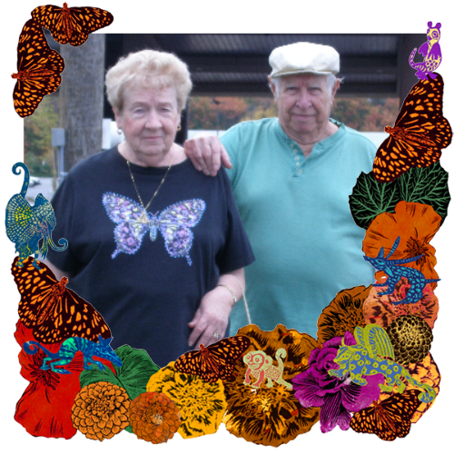 Photo of My parents in a frame with marigolds, flowers, alebrijes and monarch butterflies.