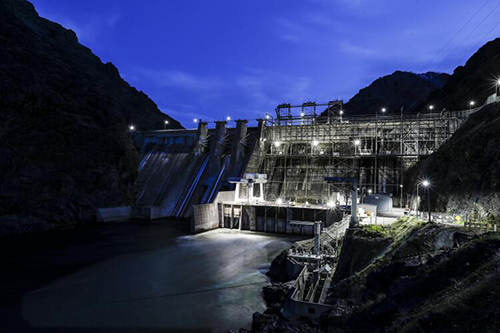 The Snake River rushes through Hells Canyon Dam as night falls on the Idaho-Oregon border.