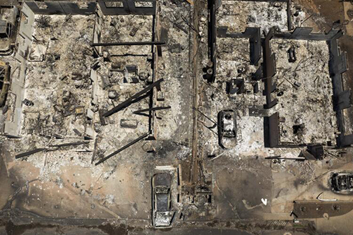 An aerial view of the scorched remains of structures