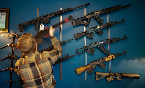Jack Brandhorst handles a rifle among others on display