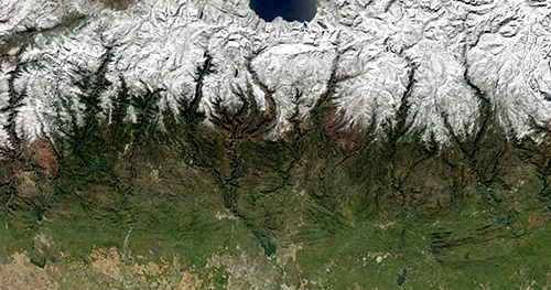 A satellite view of the Sierra Nevada covered in snow