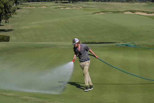 JJ Bennett waters the ninth hole during the First Look for the U.S. Open Championship 2022, in Los Angeles.