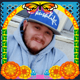 Photo of Manuel Alberto Soto jr. in an illustrated frame of blue and green papel picado, with a monarch butterfly, marigold flowers and candles.