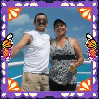 Photo of Samuel and Maria Benitez in an illustrated frame of purple papel picado, with monarch butterfly wings.