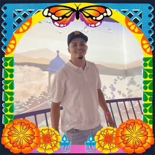 Photo of Ruben Ramon Perez in an illustrated frame of blue and green papel picado, with a monarch butterfly, marigold flowers and candles.