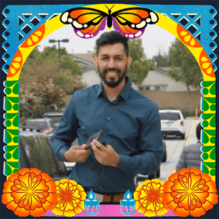 Photo of Giovanni Graciano in an illustrated frame of blue and green papel picado, with a monarch butterfly, marigold flowers and candles.