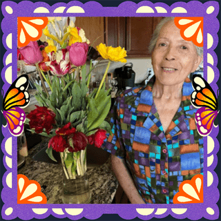 Photo of Berta Navarro in an illustrated frame of purple papel picado, with monarch butterfly wings.